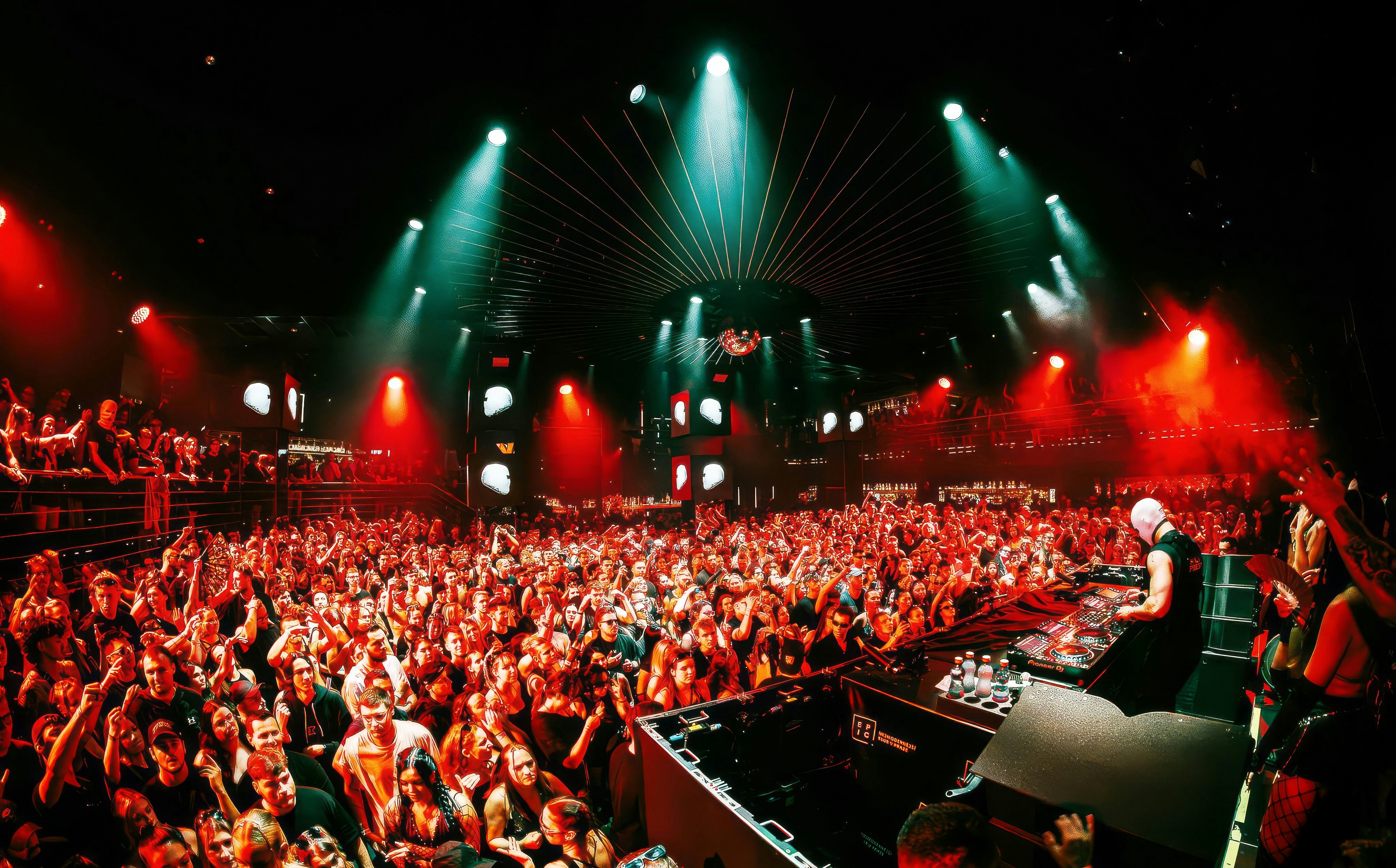DJ performing at EPIC Club Prague after party with vibrant crowd and lights.