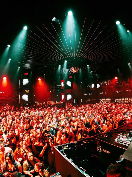 DJ performing at EPIC Club Prague after party with vibrant crowd and lights.