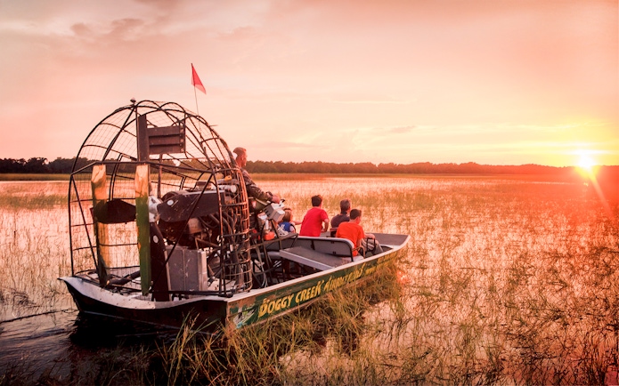Airboat on Boggy Creek at sunset during Orlando tour.
