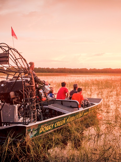 Airboat on Boggy Creek at sunset during Orlando tour.