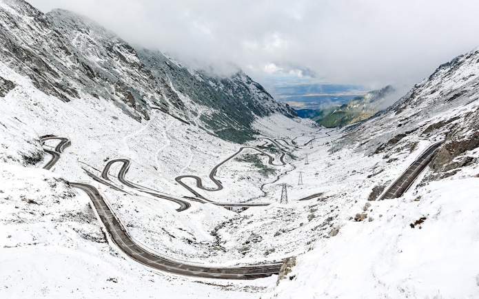 Winding Transfagarasan road covered in snow during winter, Romania.