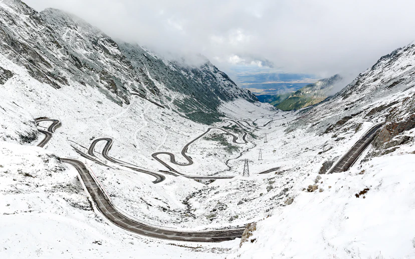 Winding Transfagarasan road covered in snow during winter, Romania.