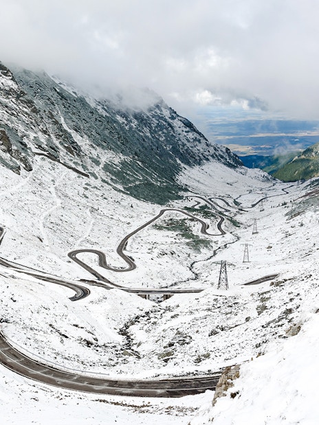 Winding Transfagarasan road covered in snow during winter, Romania.
