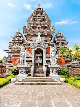 Traditional Indonesian temple at Taman Mini Indonesia, Jakarta, featuring intricate stone carvings.