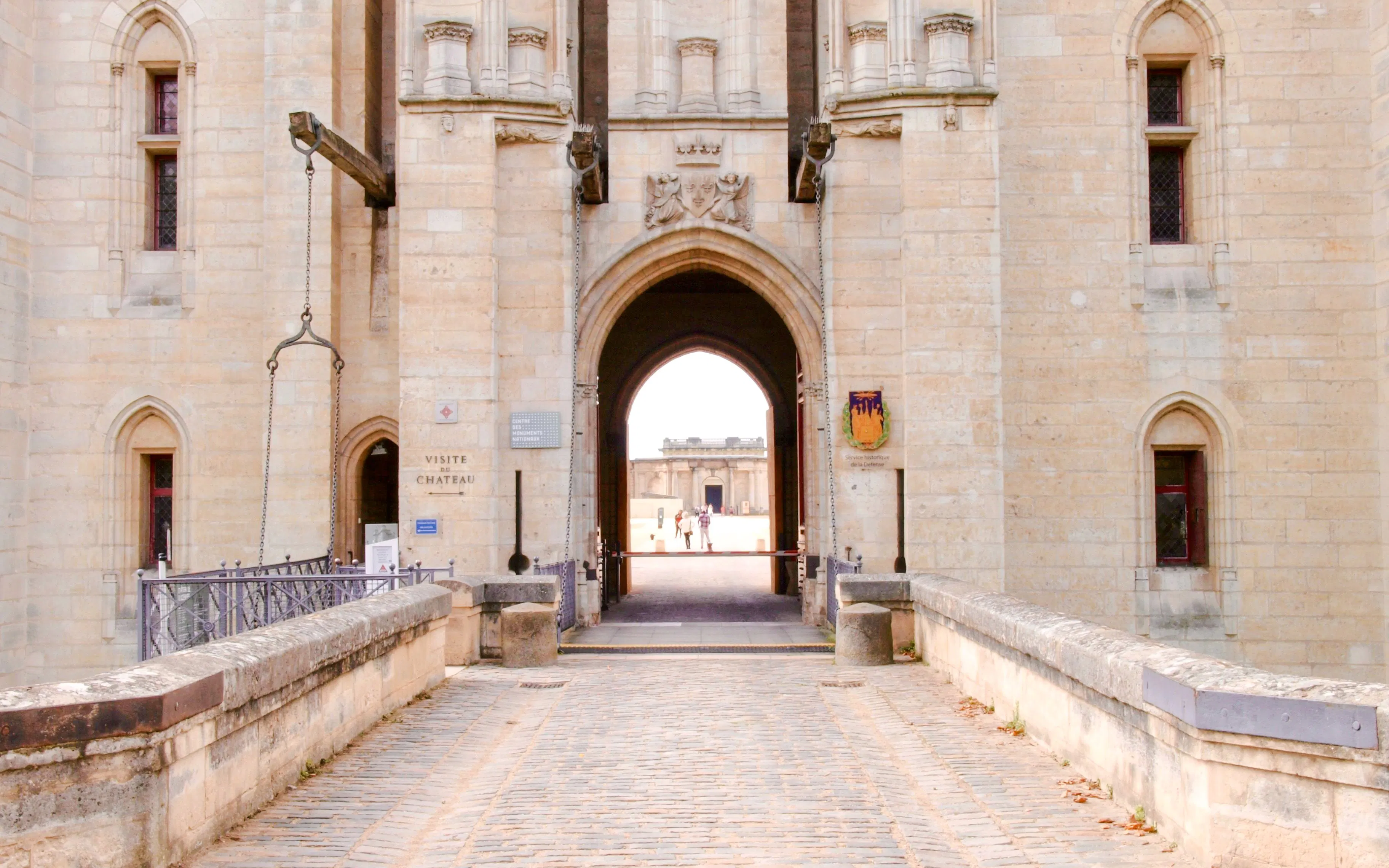 Entrance of Chateau de Vincennes with drawbridge and stone archway, Paris, France.