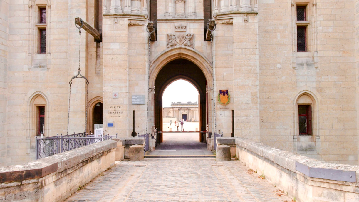 Entrance of Chateau de Vincennes with drawbridge and stone archway, Paris, France.