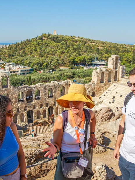 Tour group with guide at Acropolis overlooking Athens, Greece.