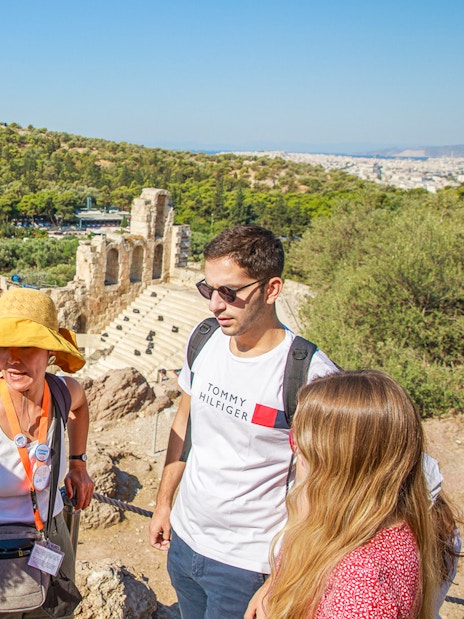 Tour group with guide at Acropolis overlooking Athens, Greece.