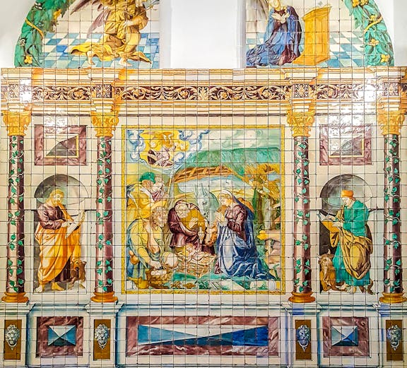 Ceramic tile mural depicting religious scene at National Tile Museum, Lisbon.