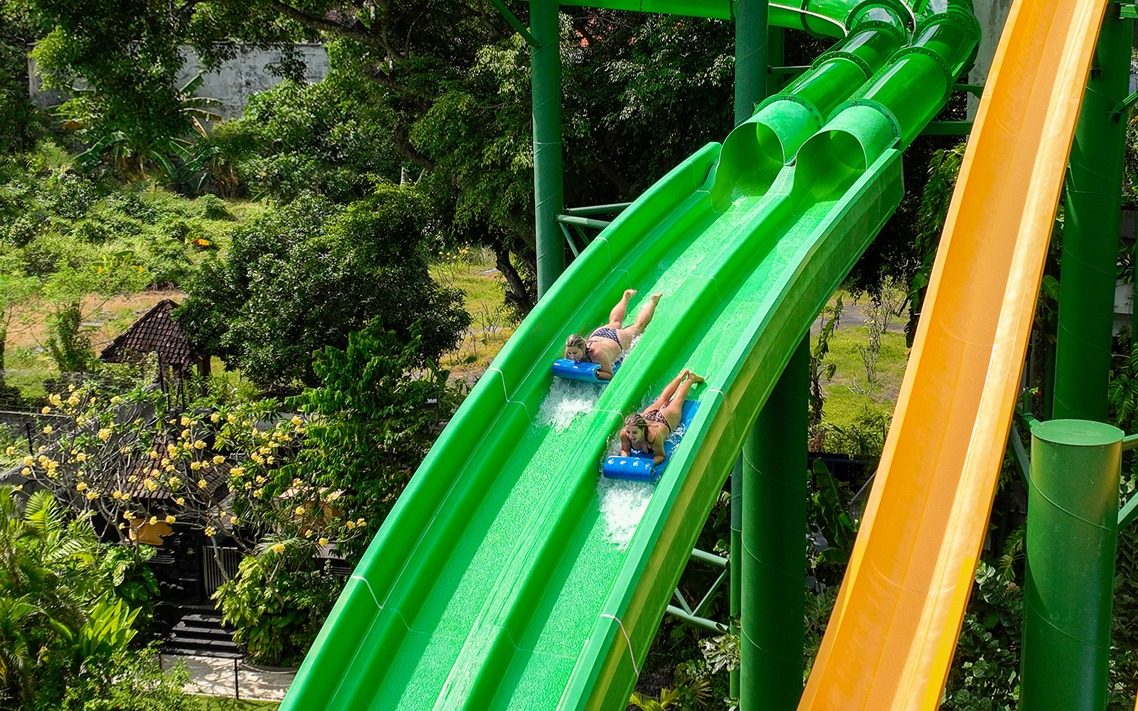 Two girls coming down the Twin Racers waterslide at Waterbom Bali water park