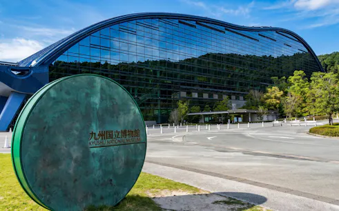 Entrance to the Kyushu National Museum with modern glass architecture in Fukuoka, Japan.