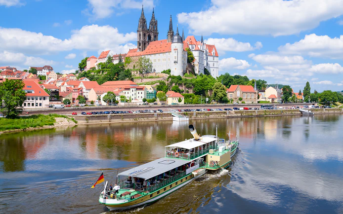 Paddle steamer on the Elbe River with Albrechtsburg Castle in Meissen in the background.