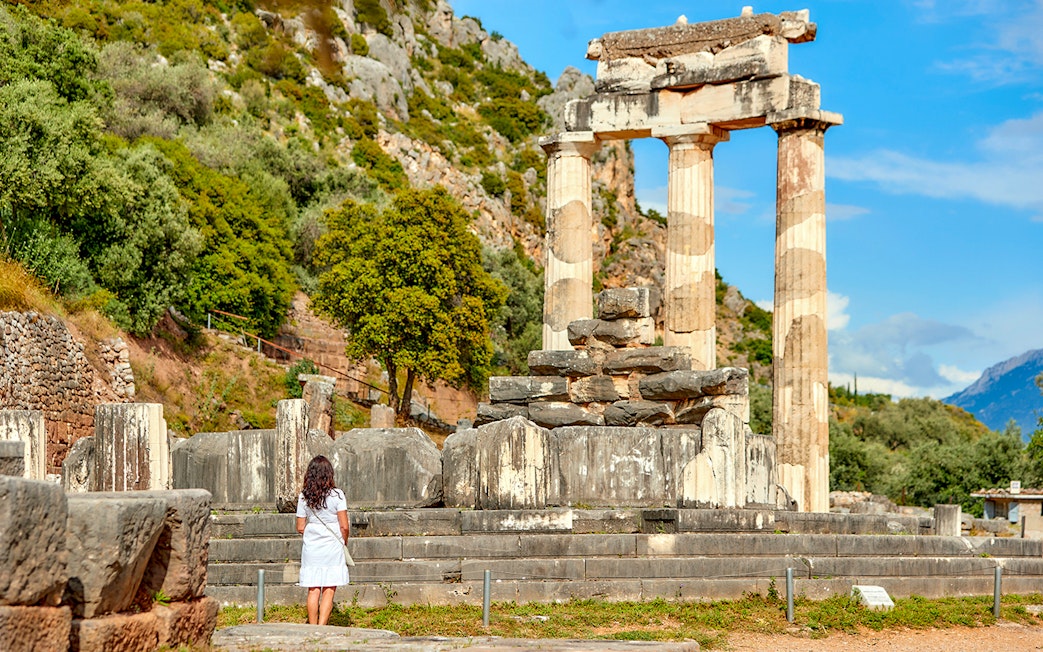 Guests exploring ancient ruins at Delphi, Greece.