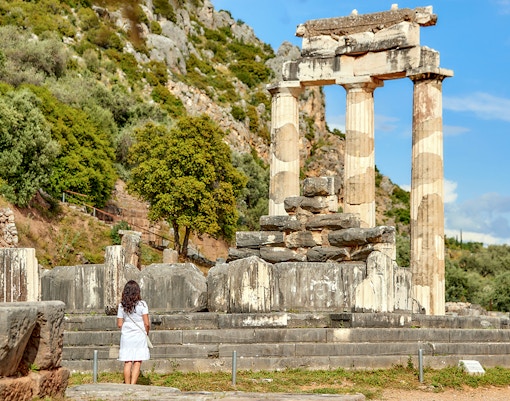 Guests exploring ancient ruins at Delphi, Greece.