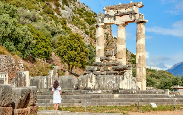 Guests exploring ancient ruins at Delphi, Greece.