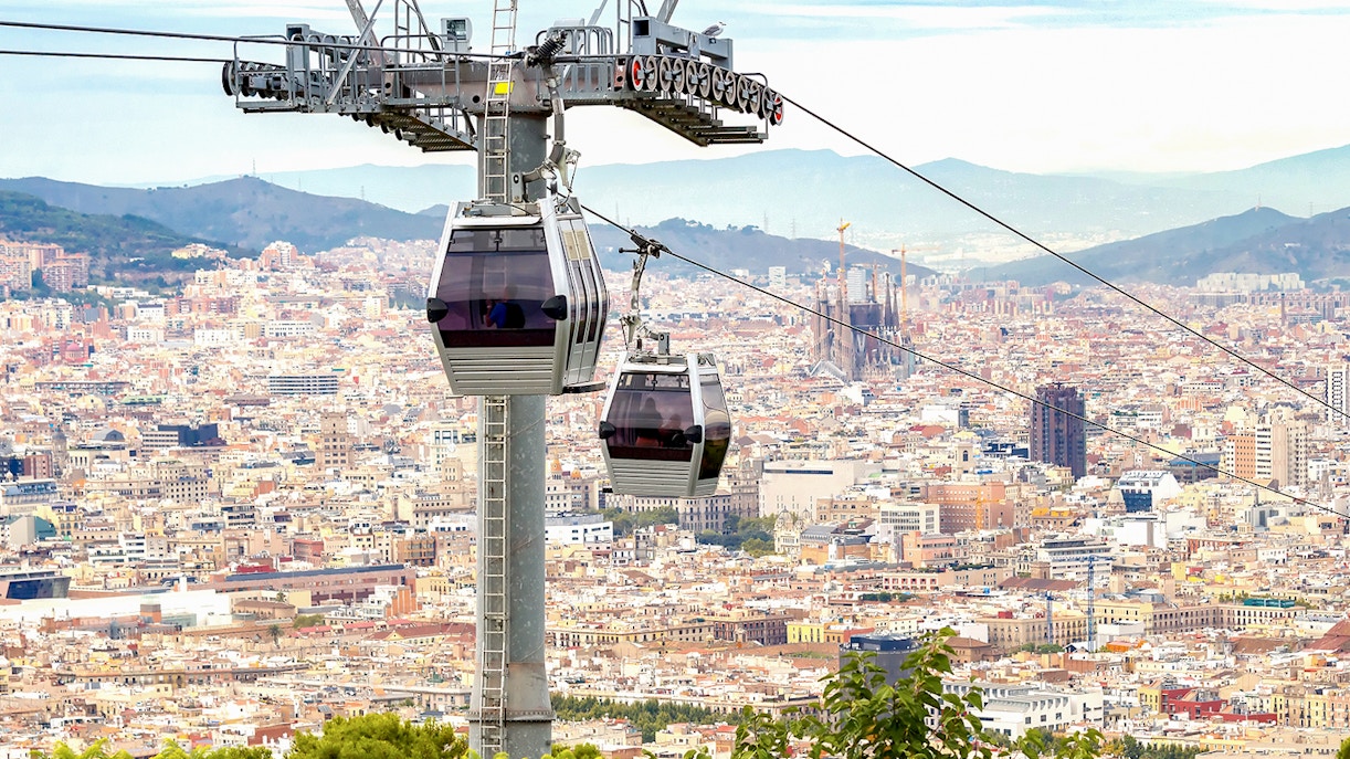 Cable car ascending Montjuic Hill with view of Sagrada Familia in back