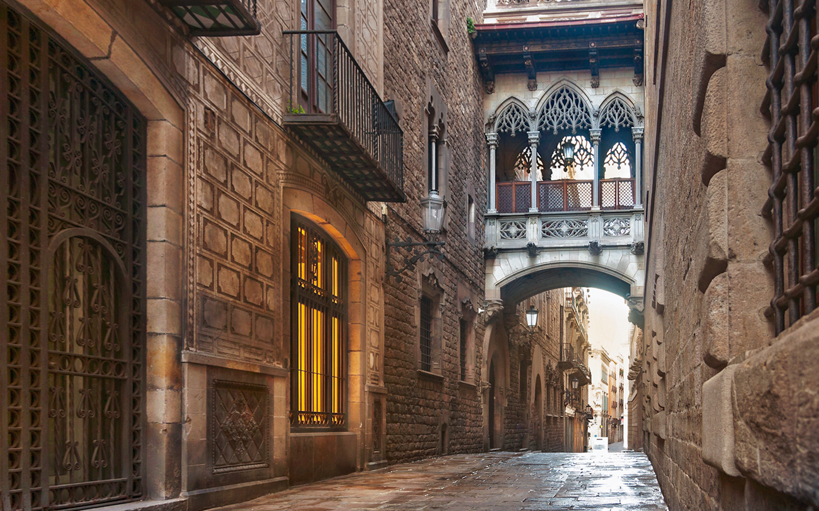 Gothic Quarter street with bridge in Barcelona, part of guided tour with music, history, and cava.
