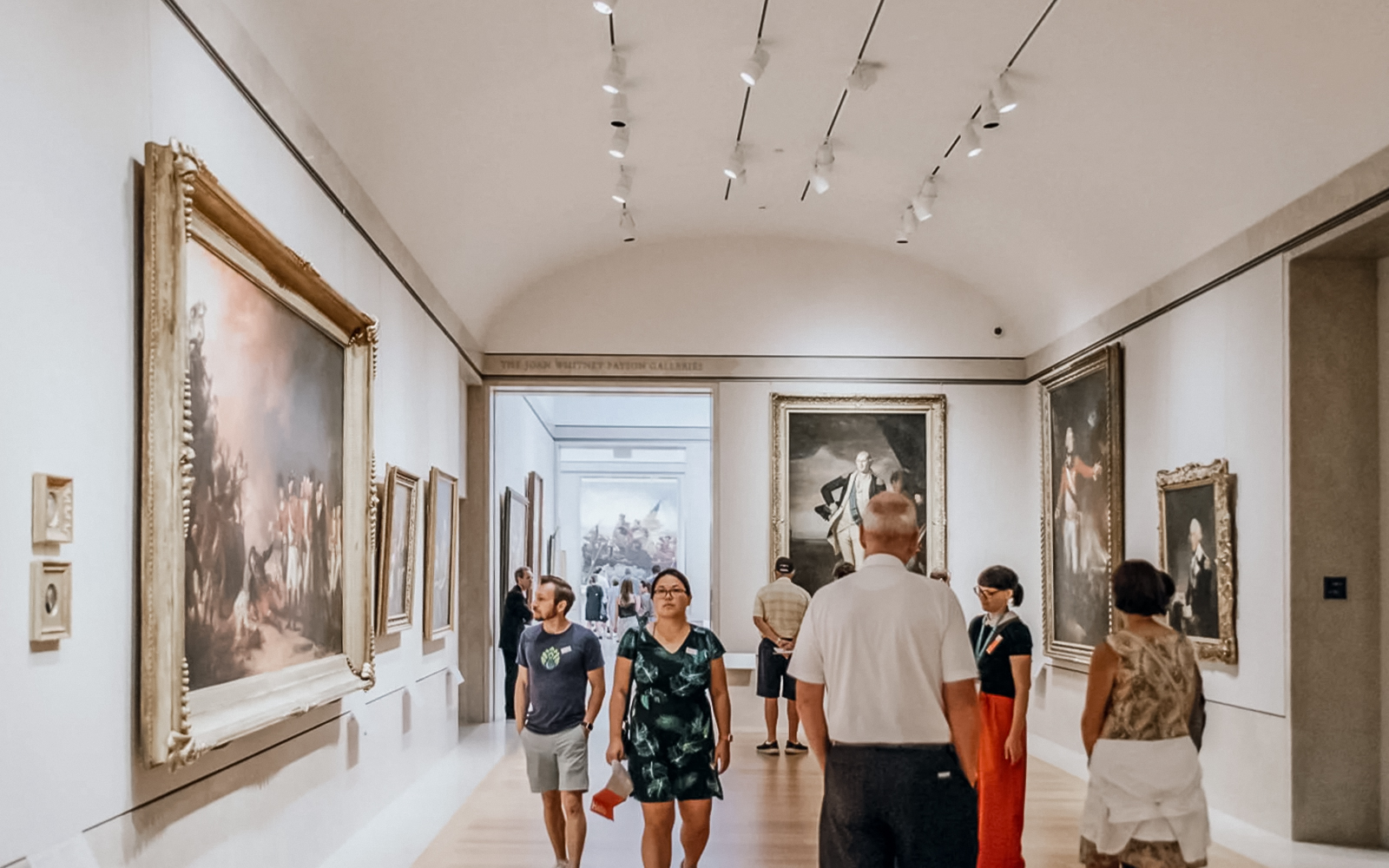Visitors exploring the Metropolitan Museum of Art's grand hall in New York City.