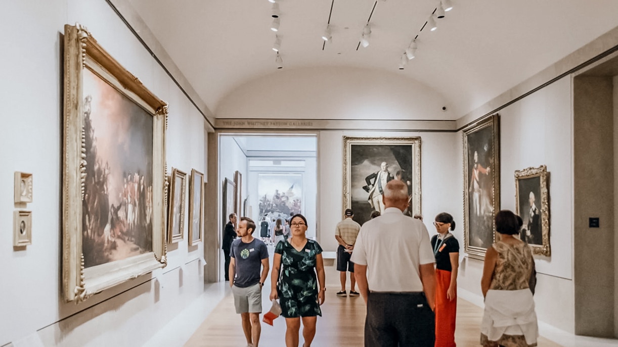 Visitors exploring the Metropolitan Museum of Art's grand hall in New York City.