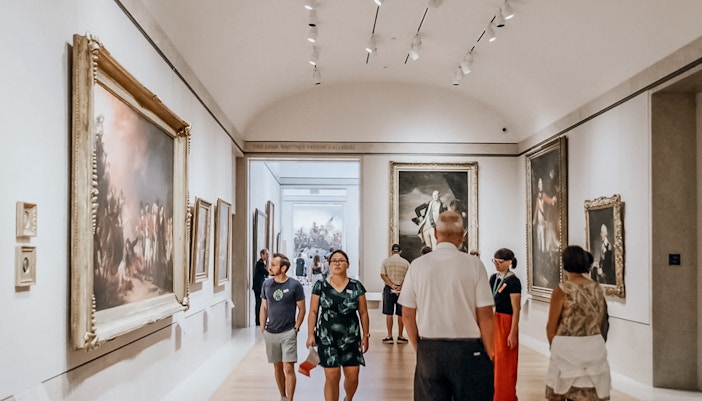 Visitors exploring the Metropolitan Museum of Art's grand hall in New York City.