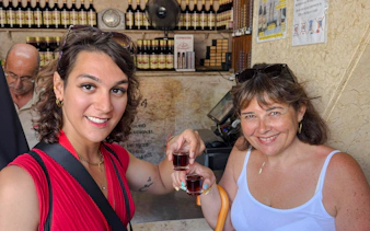 Participants enjoying a vegan wine tasting in Lisbon shop.