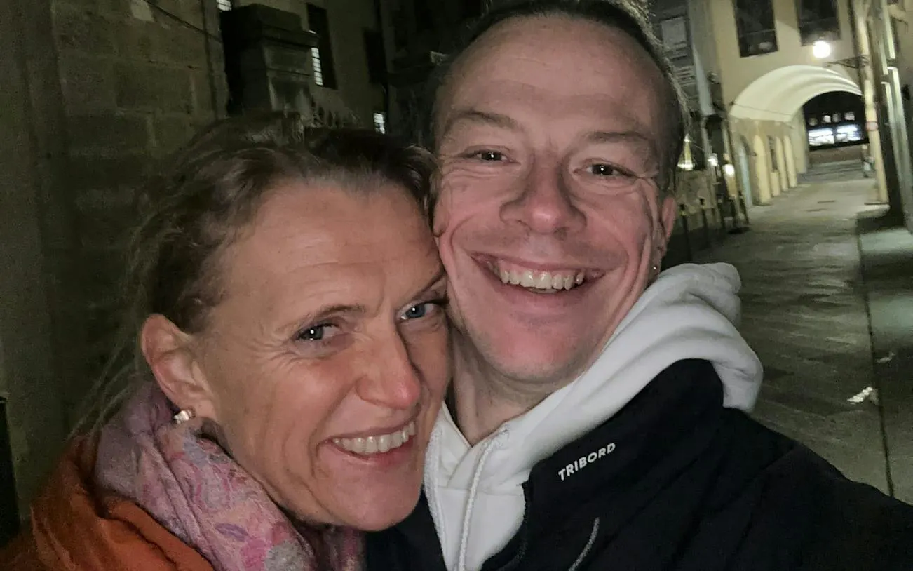 Couple smiling on a nighttime street in Florence during a detective mystery game.
