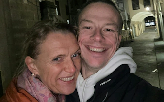 Couple smiling on a nighttime street in Florence during a detective mystery game.
