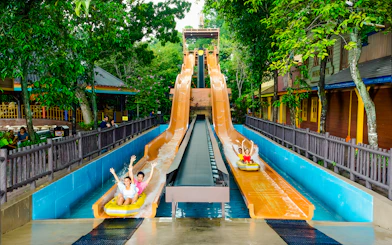 Visitors enjoying water slides at Sunway Lagoon amusement park.