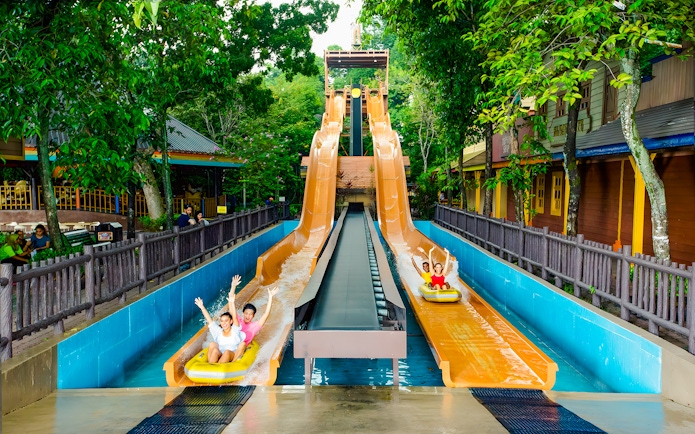 Visitors enjoying water slides at Sunway Lagoon amusement park.