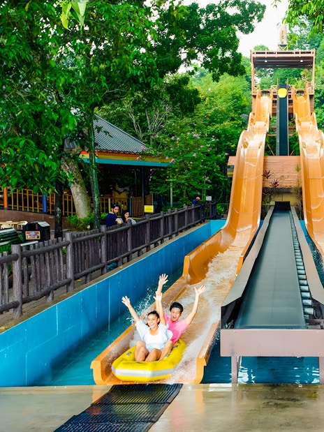 Visitors enjoying water slides at Sunway Lagoon amusement park.