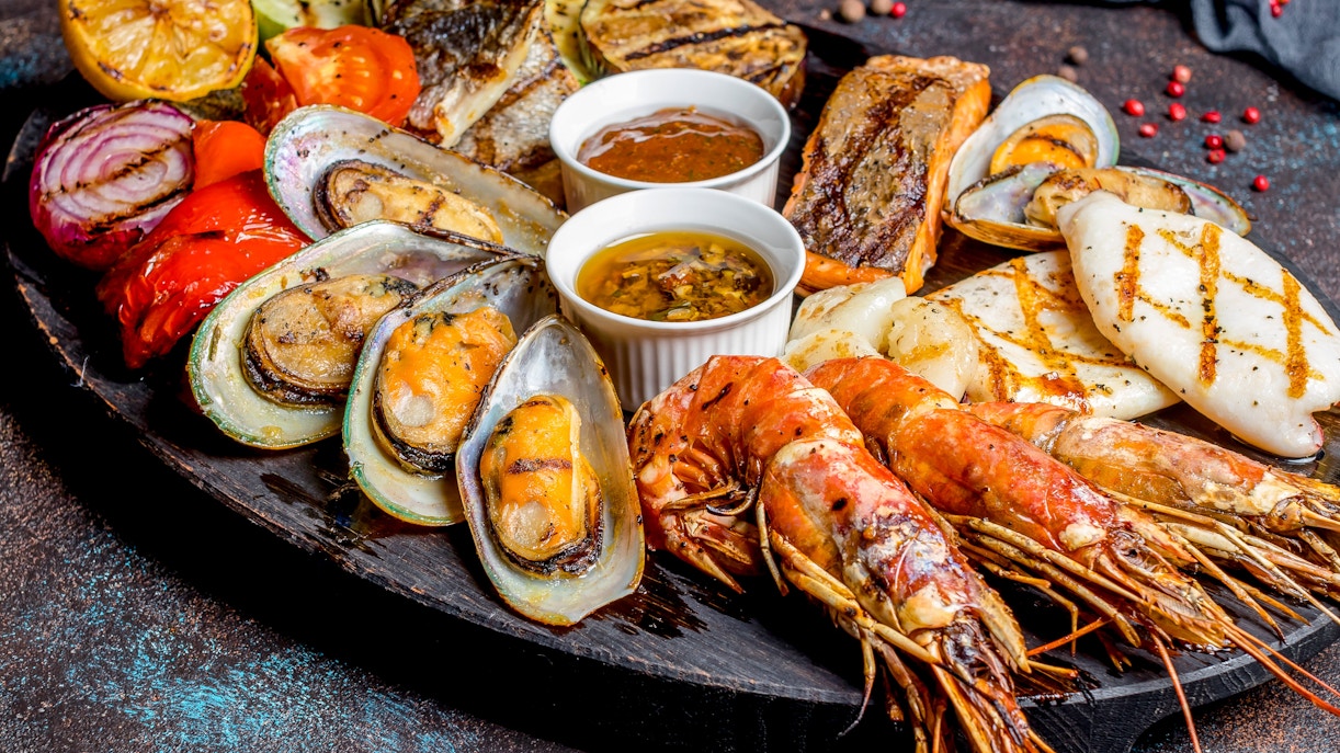 Grilled seafood platter with prawns, mussels, and fish on the French Riviera.