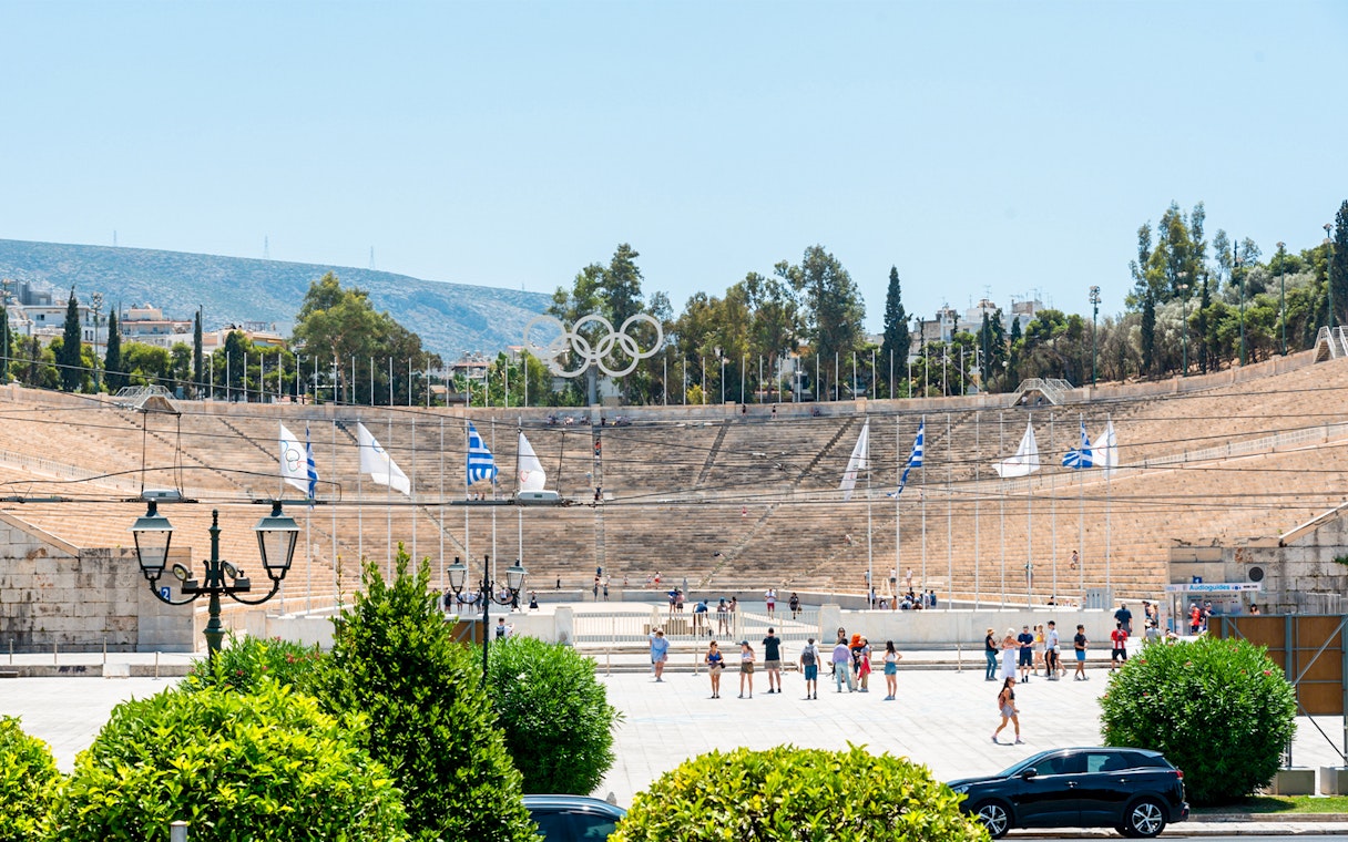 Panathenaic Stadium in Athens with tourists exploring the historic site.