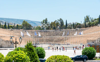 Panathenaic Stadium in Athens with tourists exploring the historic site.