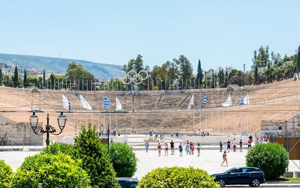 Panathenaic Stadium in Athens with tourists exploring the historic site.