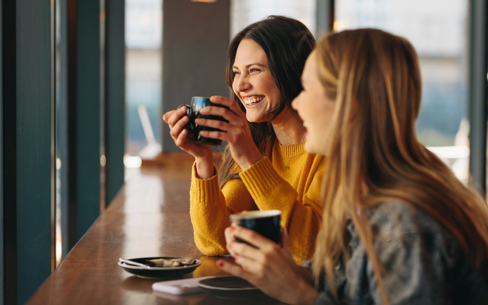 women enjoying coffee inside coffee shop