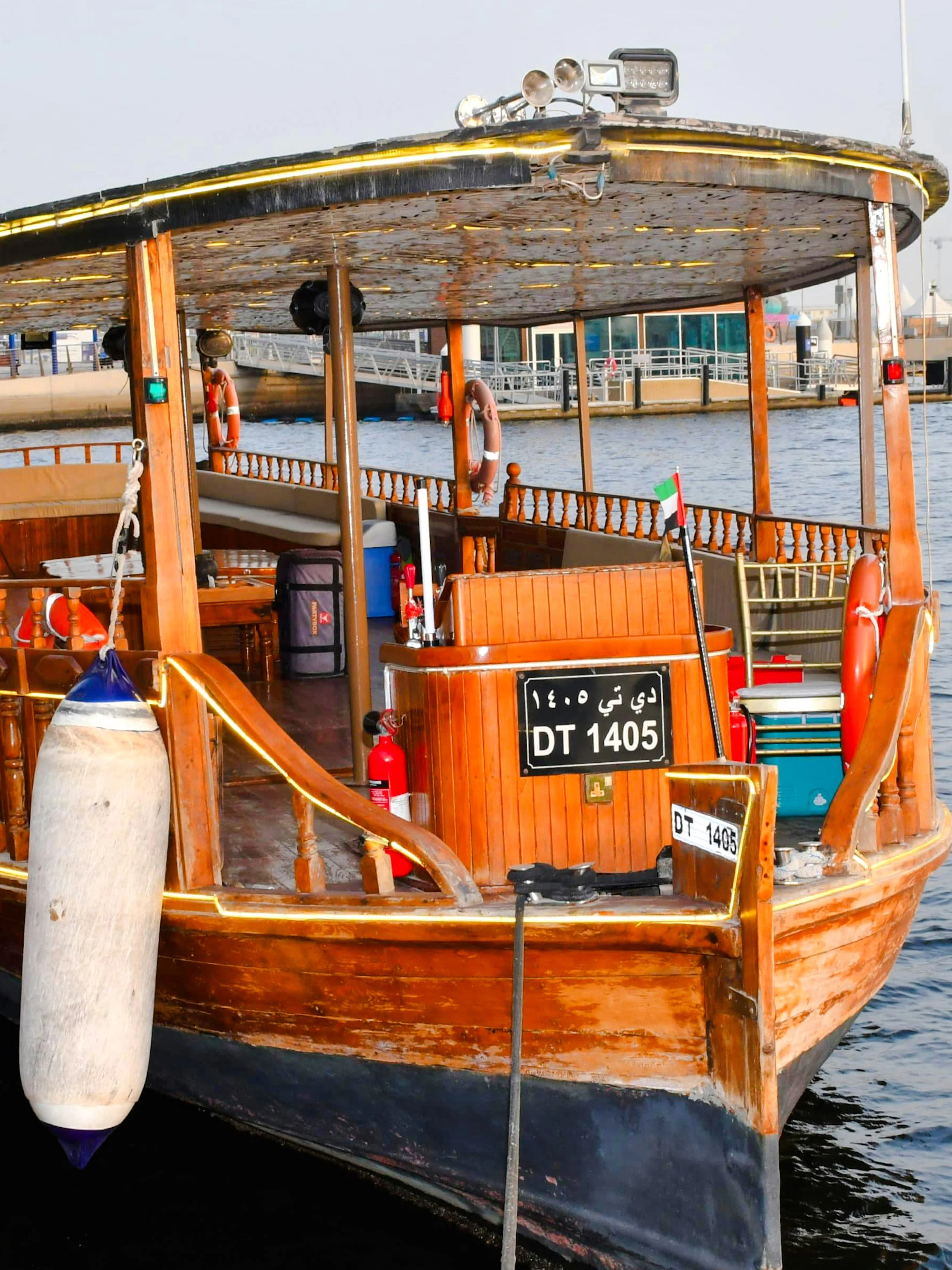 Traditional wooden abra docked for private Emirati seafood tour in Dubai.