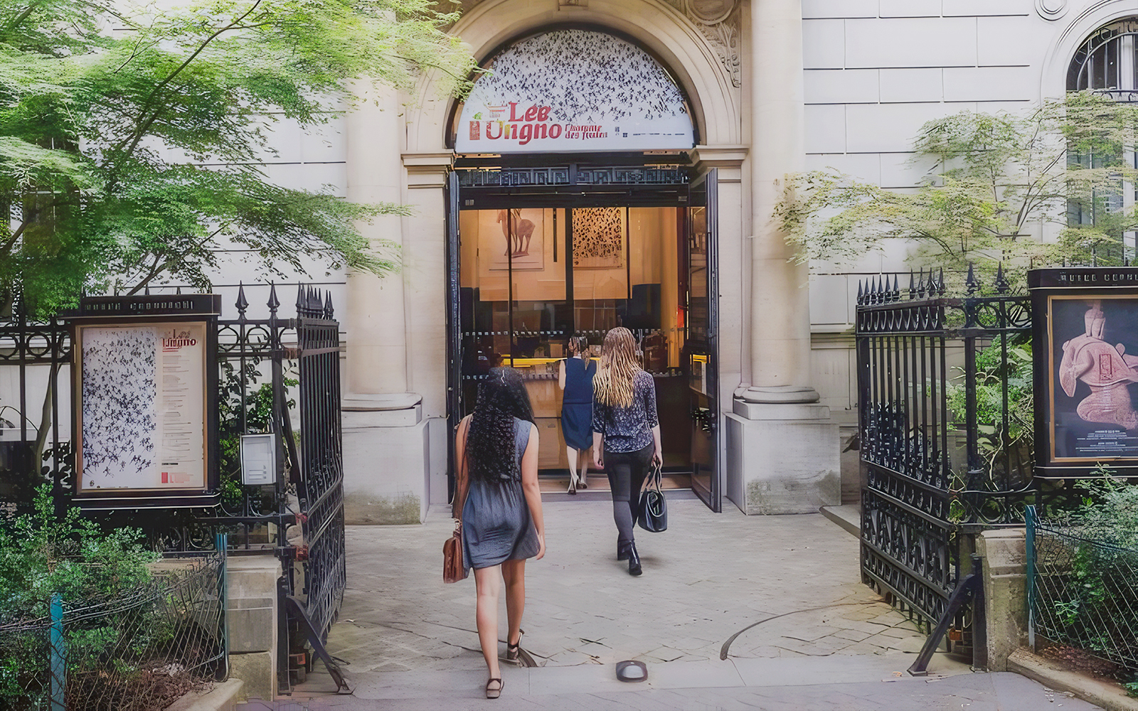 Visitors entering the Cernuschi Museum in Paris through an ornate gate.