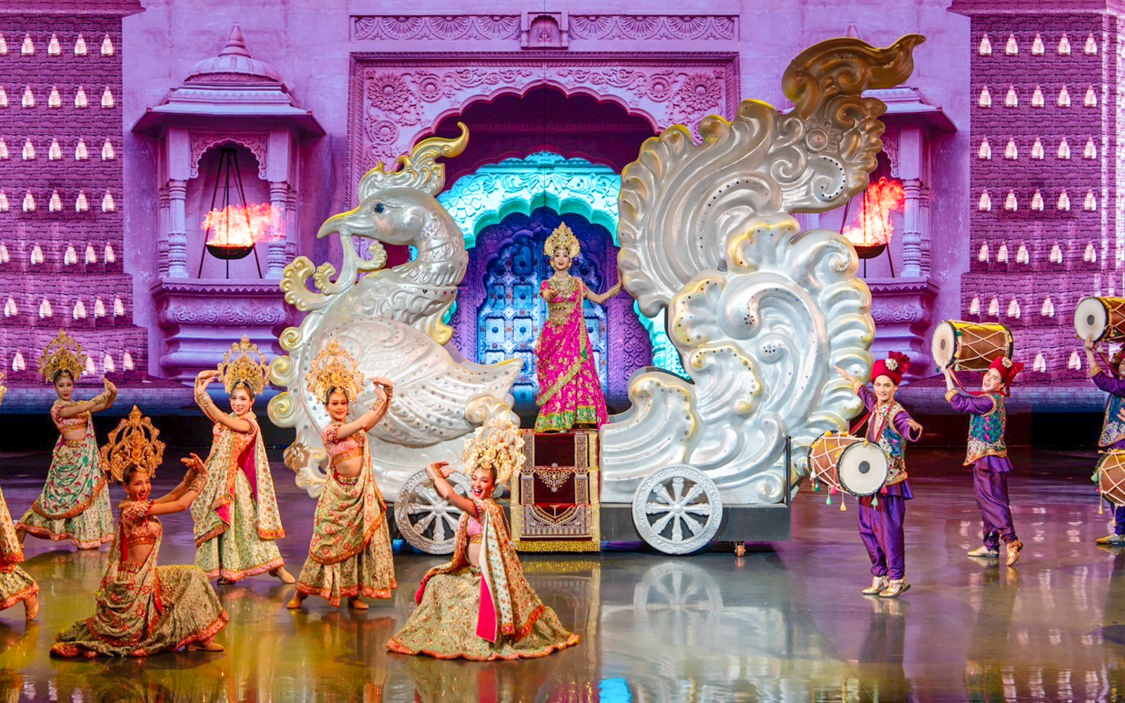Performers in traditional costumes on stage at Colosseum Cabaret Show Pattaya.