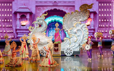 Performers in traditional costumes on stage at Colosseum Cabaret Show Pattaya.