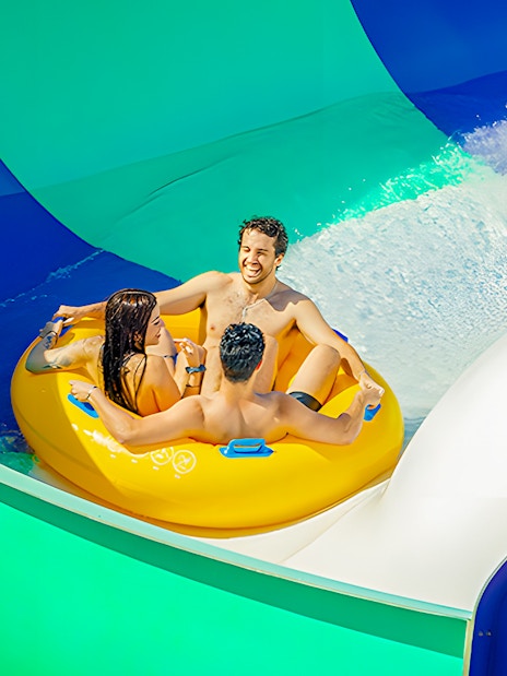 Rafting down a colorful water slide at Aquopolis Villanueva de la Cañada's Waikiki Jungle.