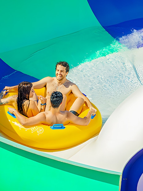 Rafting down a colorful water slide at Aquopolis Villanueva de la Cañada's Waikiki Jungle.