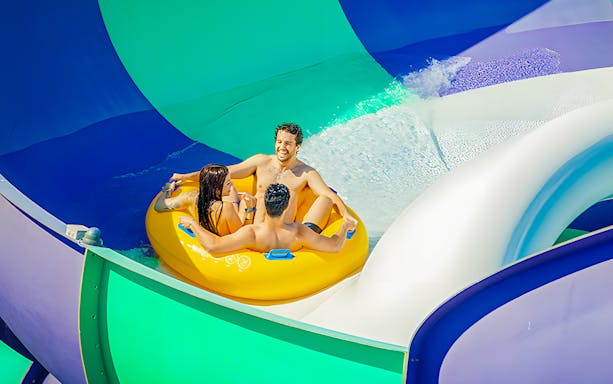 Rafting down a colorful water slide at Aquopolis Villanueva de la Cañada's Waikiki Jungle.