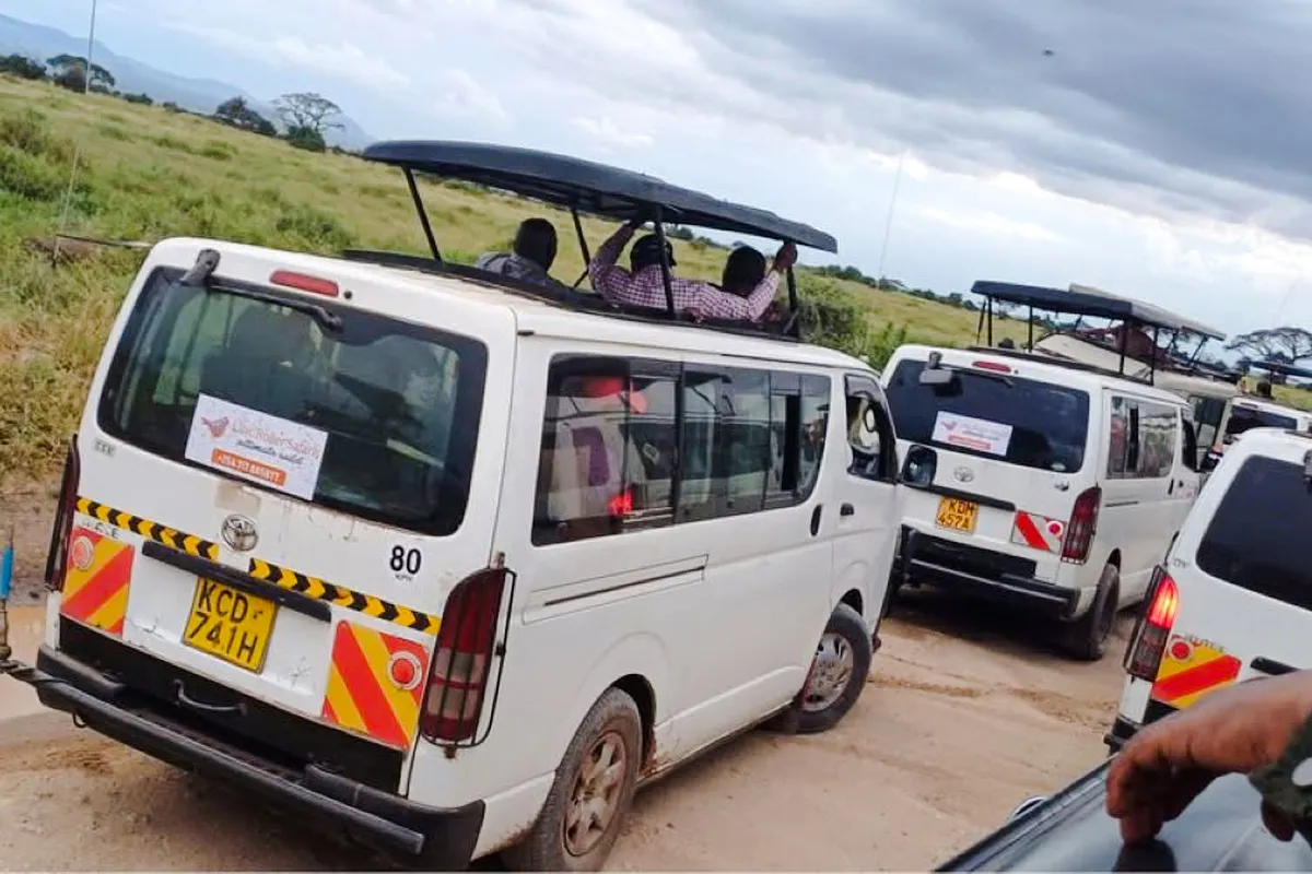 Safari vans on Amboseli Day Safari from Nairobi with open roofs for wildlife viewing.