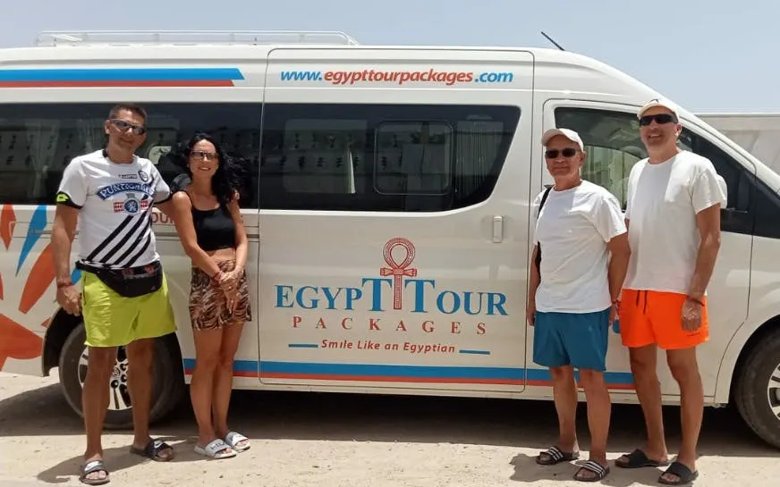 Private transfer van for Luxor to El Quseir with travelers standing beside it.
