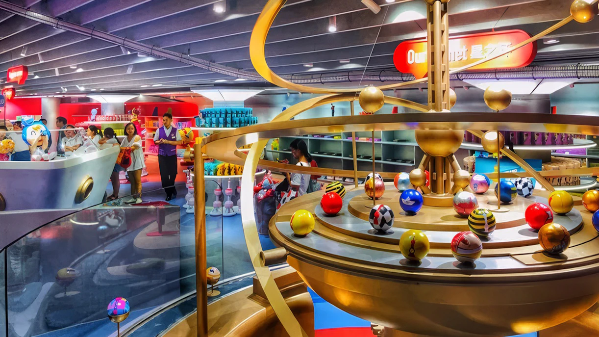 Souvenir shop inside Oriental Pearl Tower, Shanghai, featuring colorful displays and visitors browsing.