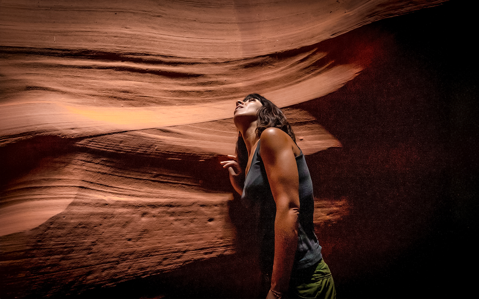 Visitor exploring sandstone formations in Upper Antelope Canyon, Page, Arizona.