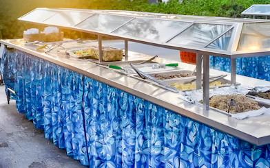 Buffet setup with traditional Polynesian dishes at Germaine's Luau.