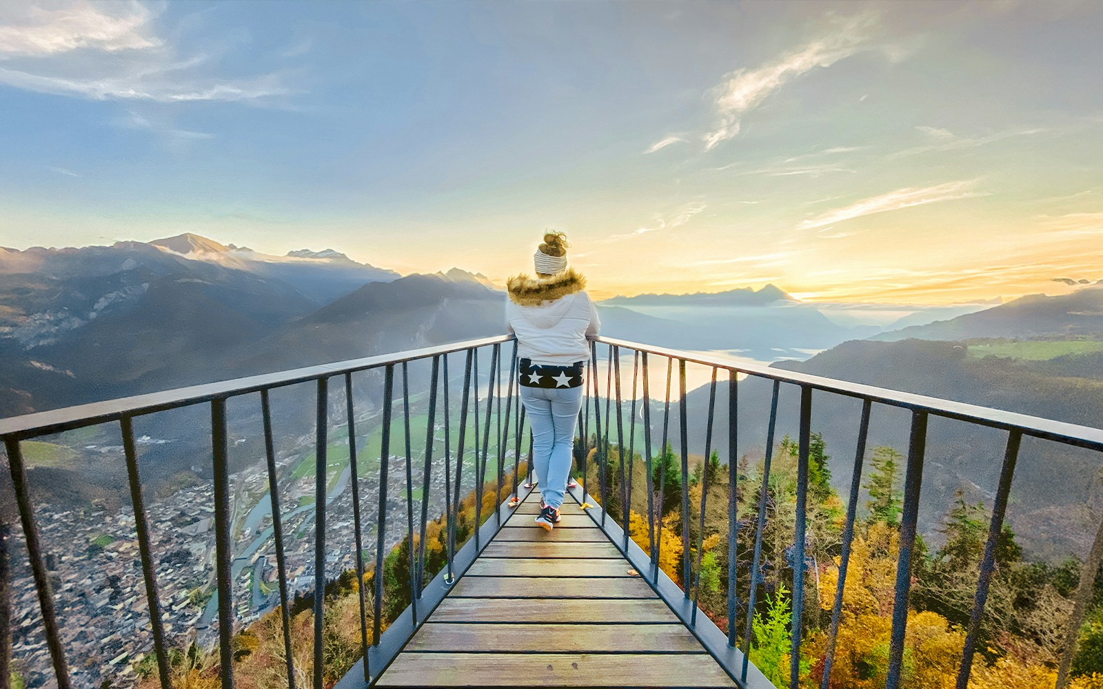 Harder Kulm viewpoint overlooking Interlaken at sunset, showcasing panoramic views of Swiss Alps.