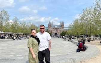Rijksmuseum in Amsterdam with visitors enjoying the plaza.