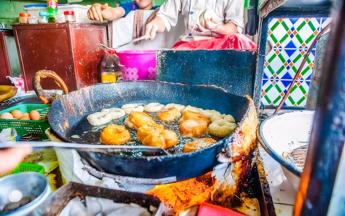 Frying pastries at a street food stall in Jema el Fna, Marrakesh.